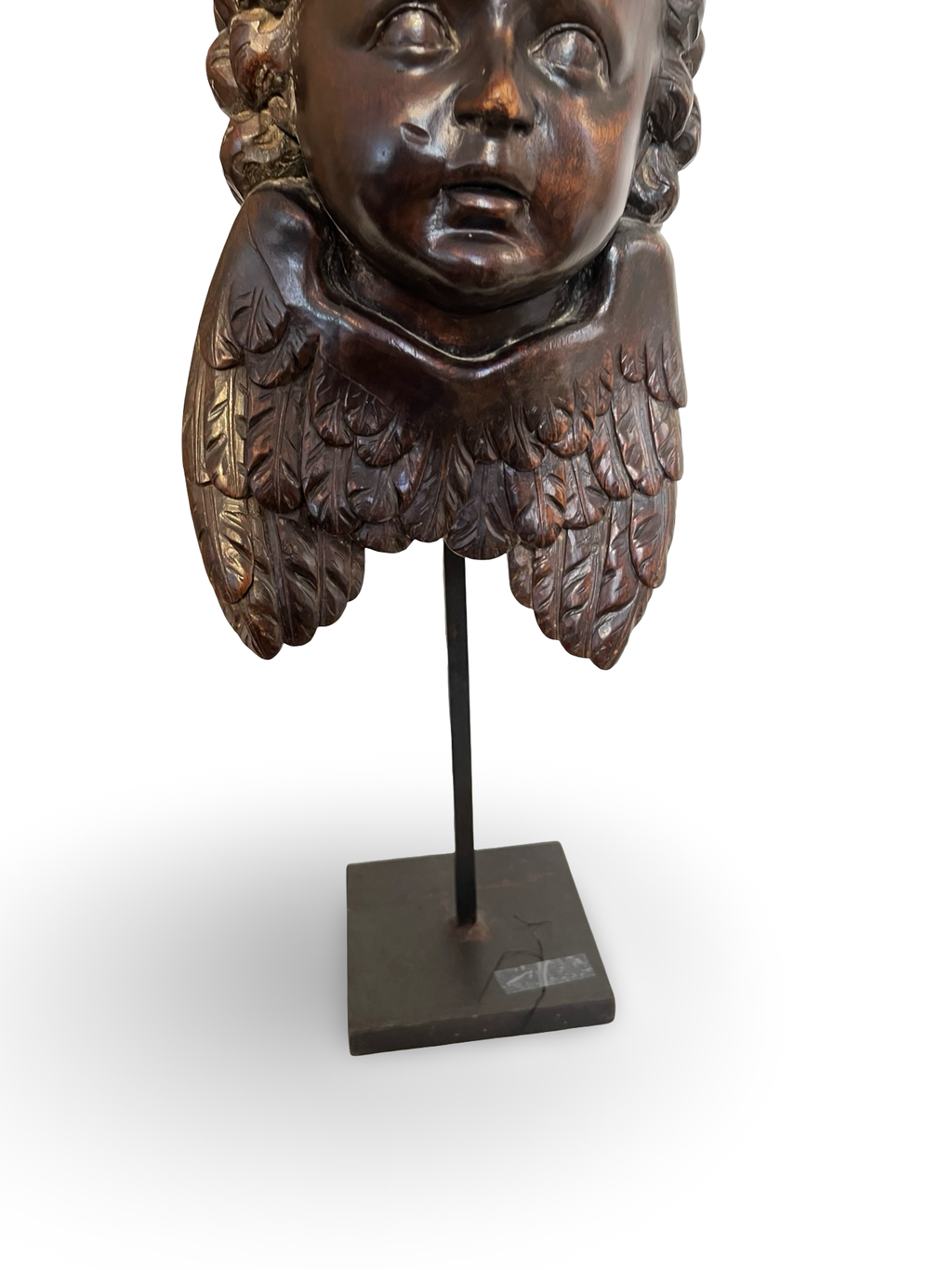 Finely carved wooden cherub head with layered wings